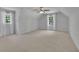 Spacious bedroom with a ceiling fan, carpet flooring, and large windows at 2095 Honeysuckle Dr, Cumming, GA 30040