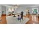 Dining area with wood floors, decorative chandelier and views into kitchen and living areas at 2095 Honeysuckle Dr, Cumming, GA 30040