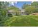Traditional home with a well maintained lawn, landscaping, and mature trees at 2095 Honeysuckle Dr, Cumming, GA 30040