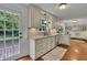 Well-lit kitchen with stone countertops, white cabinets, stainless steel appliances, and hardwood floors at 2095 Honeysuckle Dr, Cumming, GA 30040
