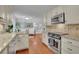 Bright kitchen with stainless steel appliances, granite countertops, and views into the cozy living room at 2095 Honeysuckle Dr, Cumming, GA 30040