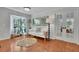 Cozy living room featuring a bay window, hardwood floors, a decorative mirror, and bright white paint at 2095 Honeysuckle Dr, Cumming, GA 30040