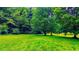 Expansive backyard featuring a lush green lawn and mature trees at 3150 Stratford Green Pl, Avondale Estates, GA 30002