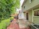 A backyard with a patio, landscaping, and green trees at 3150 Stratford Green Pl, Avondale Estates, GA 30002
