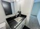 This bathroom features a sleek design with a white sink, black countertop, and modern fixtures at 3150 Stratford Green Pl, Avondale Estates, GA 30002