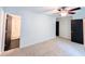 Bright bedroom shows carpet, neutral walls, doors, with a view of the adjoining bathroom and closet at 3150 Stratford Green Pl, Avondale Estates, GA 30002