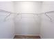 Uncluttered walk-in closet featuring basic white shelving and neutral carpet at 3150 Stratford Green Pl, Avondale Estates, GA 30002