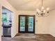Dining area featuring backyard views, modern lighting, and open access to the kitchen at 3150 Stratford Green Pl, Avondale Estates, GA 30002