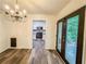Dining room with wood floors open to kitchen and patio at 3150 Stratford Green Pl, Avondale Estates, GA 30002
