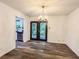 Open dining room with chandelier and views of the backyard and kitchen at 3150 Stratford Green Pl, Avondale Estates, GA 30002