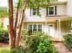 Charming two-story home featuring manicured greenery and a welcoming front porch at 3150 Stratford Green Pl, Avondale Estates, GA 30002