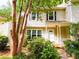 Inviting two-story home with a covered porch and lush landscaping at 3150 Stratford Green Pl, Avondale Estates, GA 30002