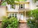 Cozy two-story home with a covered entrance and verdant bushes at 3150 Stratford Green Pl, Avondale Estates, GA 30002