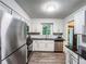 Bright kitchen with stainless steel appliances, white cabinets, wood floors, and black countertops at 3150 Stratford Green Pl, Avondale Estates, GA 30002