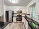 Modern kitchen featuring stainless steel appliances, white cabinets, and black countertops at 3150 Stratford Green Pl, Avondale Estates, GA 30002