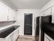 Updated kitchen featuring black countertops, wood floors, and stainless steel appliances at 3150 Stratford Green Pl, Avondale Estates, GA 30002