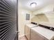 Laundry room with appliances and shelving, complete with louvred door at 3150 Stratford Green Pl, Avondale Estates, GA 30002