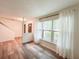 Open-concept room with wood-look floors, a large window, and neutral-toned walls at 3150 Stratford Green Pl, Avondale Estates, GA 30002