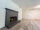 Spacious living room with a dark brick fireplace and wood-look floors at 3150 Stratford Green Pl, Avondale Estates, GA 30002