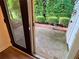 View of a patio with well-maintained landscaping and a door to the home at 3150 Stratford Green Pl, Avondale Estates, GA 30002