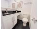 Bright powder room featuring a sleek vanity with black countertop and modern faucet, plus stylish wall decor at 3150 Stratford Green Pl, Avondale Estates, GA 30002