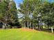 A sprawling lush green lawn with beautiful tall trees offering lots of shade at 3150 Stratford Green Pl, Avondale Estates, GA 30002