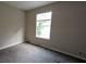 Neutral bedroom featuring a window, beige walls, and carpet flooring at 3778 Glen Mora Dr, Decatur, GA 30032
