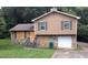 Two-story home with stone accents, wood siding, and some boarded up windows at 3778 Glen Mora Dr, Decatur, GA 30032