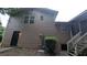 Exterior view of the home, showing the siding, screened in back porch, and access to the basement at 3778 Glen Mora Dr, Decatur, GA 30032
