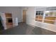 Open living room featuring boarded window and fireplace at 3778 Glen Mora Dr, Decatur, GA 30032
