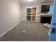 A living room with carpeted floors adjacent to the kitchen and dining space at 3778 Glen Mora Dr, Decatur, GA 30032