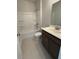 Clean bathroom featuring a shower-tub combo with tile flooring and a wood vanity at 4266 Mulberry Pass Ct, Hoschton, GA 30548