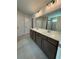 Bathroom featuring double sink vanity, tile flooring, and a large mirror with modern lighting at 4266 Mulberry Pass Ct, Hoschton, GA 30548