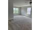 Bedroom with neutral walls, neutral carpet, a ceiling fan, and multiple windows providing ample natural light at 4266 Mulberry Pass Ct, Hoschton, GA 30548