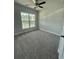 Carpeted bedroom features neutral walls and large window providing plenty of natural light at 4266 Mulberry Pass Ct, Hoschton, GA 30548