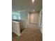 Hallway featuring neutral colored carpet and gray walls connecting various rooms in the home at 4266 Mulberry Pass Ct, Hoschton, GA 30548