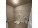 Laundry room featuring tile flooring, utility sink, and a wire shelf for storage and organization at 4266 Mulberry Pass Ct, Hoschton, GA 30548