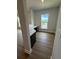 Home office featuring a built-in desk, hardwood flooring, and natural lighting from a large window at 4266 Mulberry Pass Ct, Hoschton, GA 30548