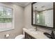Elegant bathroom with granite countertop, modern fixtures, and glass-enclosed shower at 4903 Wilkie Nw Way, Acworth, GA 30102