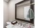 Bathroom with marble countertop, a framed mirror, and a towel rack at 4903 Wilkie Nw Way, Acworth, GA 30102
