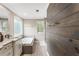 Bathroom with double vanity, jacuzzi tub, and wood accent wall at 4903 Wilkie Nw Way, Acworth, GA 30102