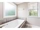 Bathroom featuring a jacuzzi tub and two windows at 4903 Wilkie Nw Way, Acworth, GA 30102