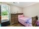 Charming bedroom with hardwood floors, large window and a comfortable twin bed at 4903 Wilkie Nw Way, Acworth, GA 30102