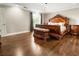 Bedroom with dark wood floors, vaulted ceiling, and luxurious wood bed frame at 4903 Wilkie Nw Way, Acworth, GA 30102