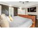 Bedroom with dark wood floors, sliding barn doors, and ceiling fan at 4903 Wilkie Nw Way, Acworth, GA 30102