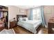 Comfortable bedroom featuring wood floors, closet, curtains, and a plush bed at 4903 Wilkie Nw Way, Acworth, GA 30102