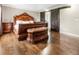 Bedroom with dark wood floors, sliding barn doors and luxurious wood bed frame at 4903 Wilkie Nw Way, Acworth, GA 30102