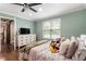 Spacious bedroom with hardwood floors, large window, ceiling fan, and a TV on dresser at 4903 Wilkie Nw Way, Acworth, GA 30102