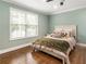 Bright bedroom with hardwood floors, a large window, and a comfortable queen bed at 4903 Wilkie Nw Way, Acworth, GA 30102