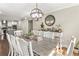 Bright dining room with an oversized wooden table and a decorative light fixture at 4903 Wilkie Nw Way, Acworth, GA 30102